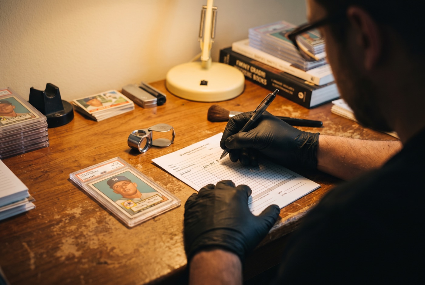 A grader in black gloves writing the final grade on a worksheet beside a slab